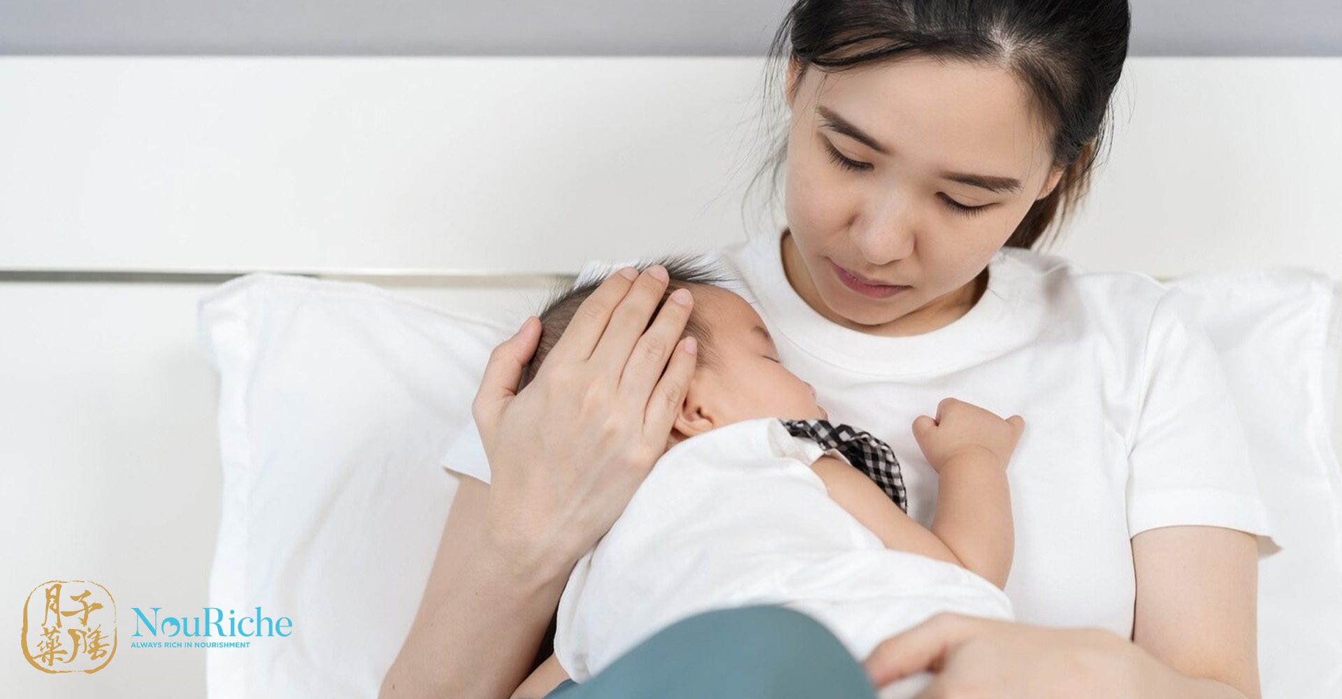 a concerned mum hugging a newborn wearing white shirt